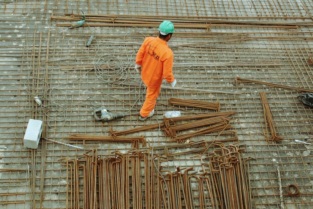 Construction Recruitment: man laying out pipes for a new building